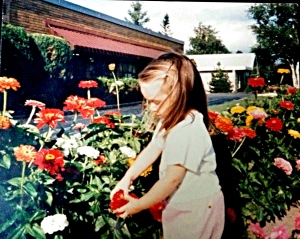 Always playing outdoors. Myself at 3 years old, fascinated by the flowers in Grandma's gardens